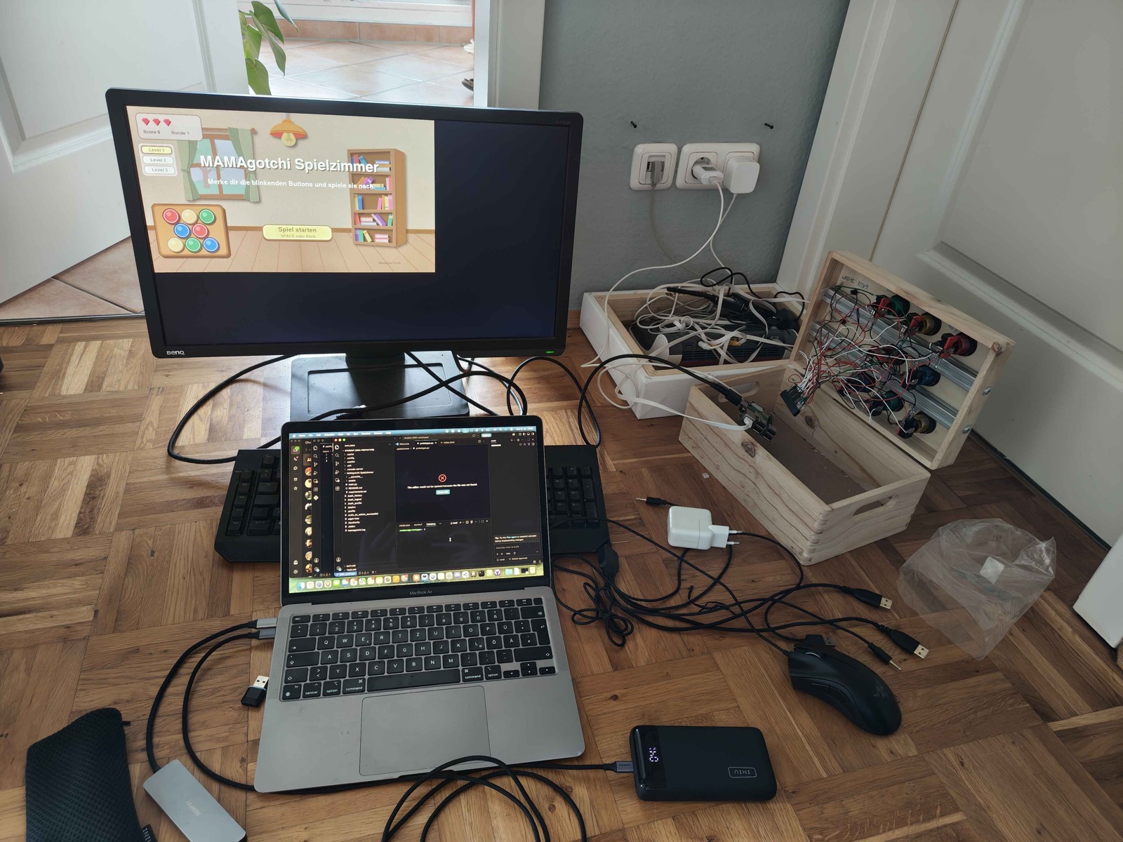 Figure 10&colon; A development / integration session&colon; the game on the monitor, the code on the laptop, and the wired box on the right.